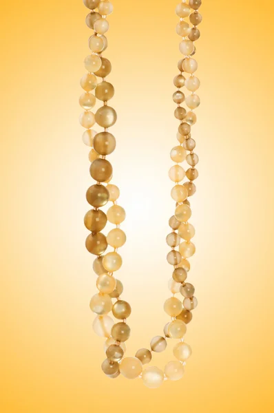 Nice necklace against gradient background — Stock Photo, Image