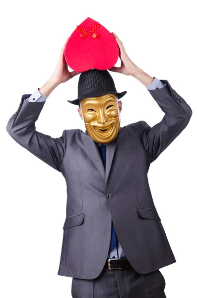 Masked man with giftbox on white — Stock Photo, Image