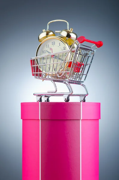 Buying time concept with clock and shopping cart Stock Picture