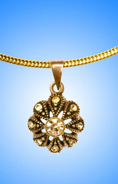 Golden jewellery against gradient background — Stock Photo, Image