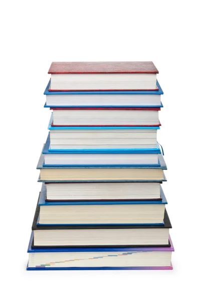 Libros en alta pila aislados en blanco —  Fotos de Stock
