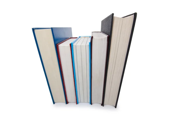 Libri in pila alta isolati su bianco — Foto Stock