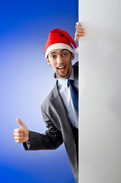 Бізнесмен у капелюсі Санта з порожнім повідомленням — стокове фото