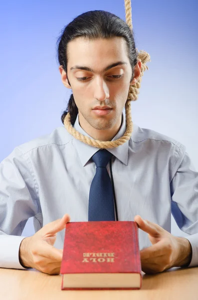 Businessman reading bible before hanging himself — Stock Photo, Image