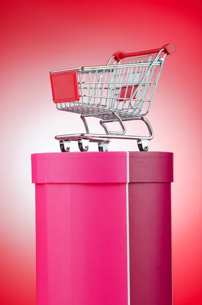 Cart and giftbox in christmas shopping concept — Stock Photo, Image
