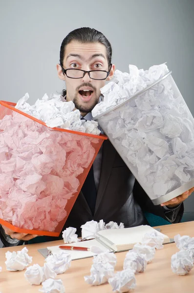 Man with lots of wasted paper Stock Image