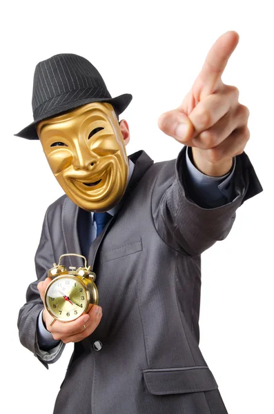 Masked man with clock on white — Stock Photo, Image