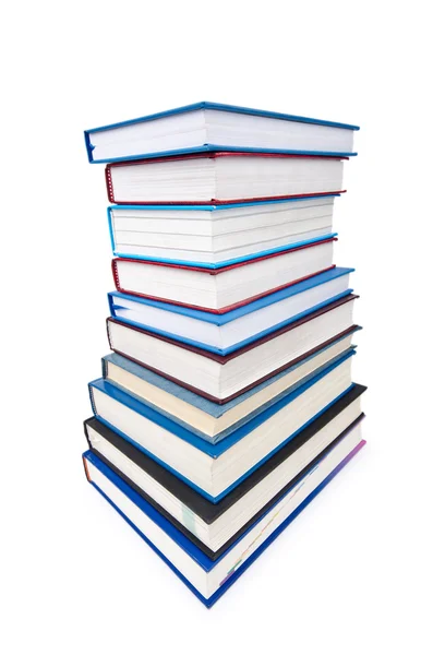Libri in pila alta isolati su bianco — Foto Stock