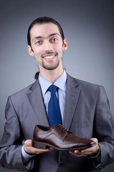 Man with a selection of shoes — Stock Photo, Image