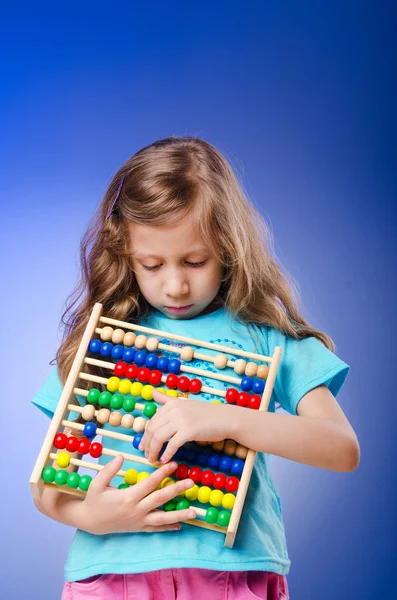 Girl playing with abacus — Stock Photo, Image