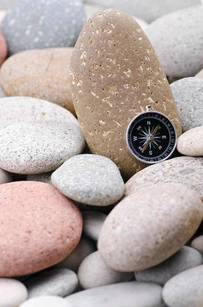 Navigation compass on stone pebbles — Stock Photo, Image