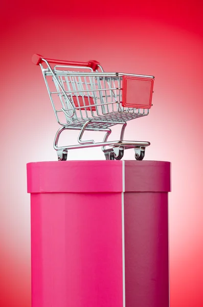 Cart and giftbox in christmas shopping concept Stock Photo