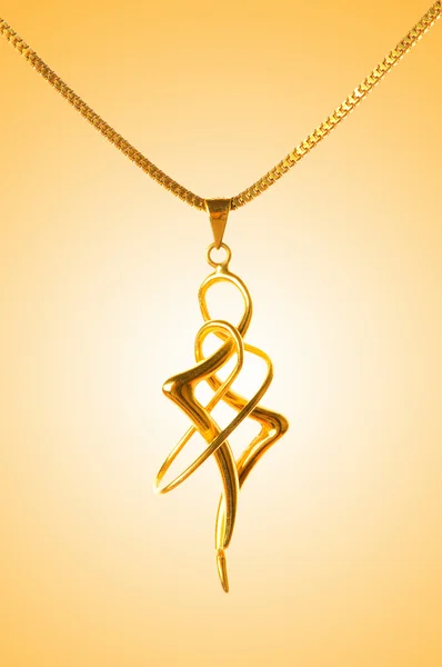 Stock image Golden jewellery against gradient background