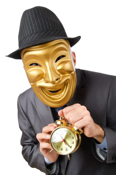 Masked man with clock on white — Stock Photo, Image