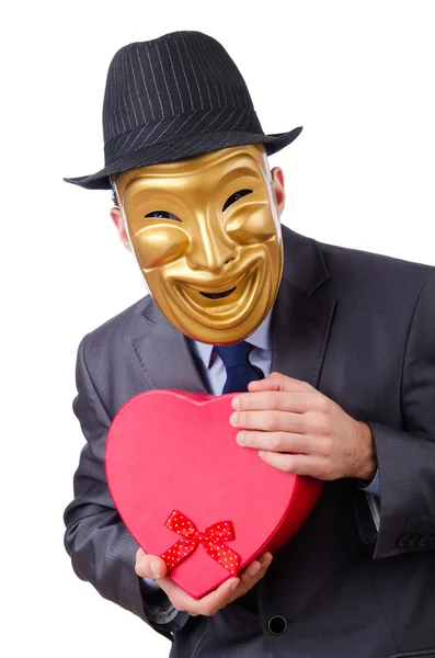 Maskierter Mann mit Geschenkbox auf weißem Hintergrund — Stockfoto
