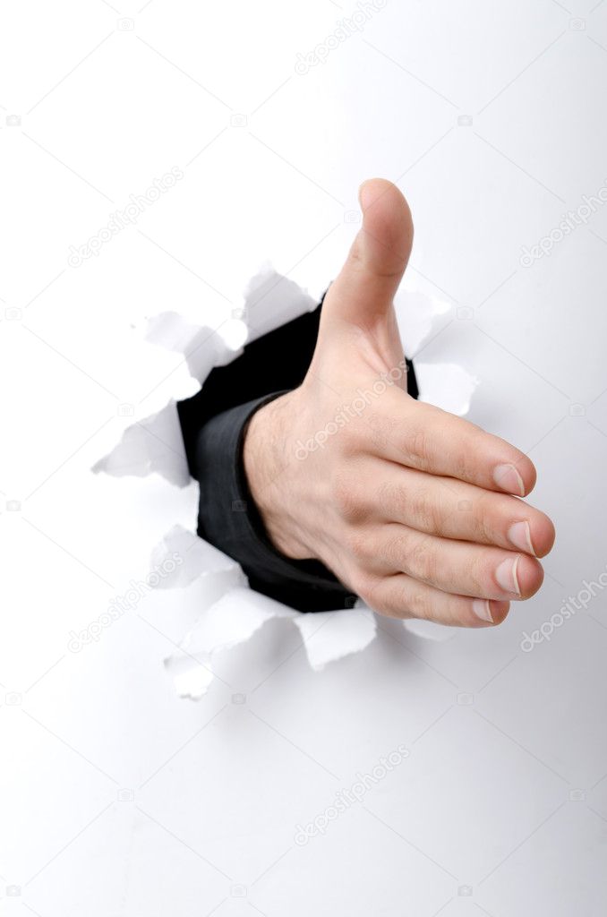 Hand With Thumb Up Through A Hole In Paper Stock Photo, Picture