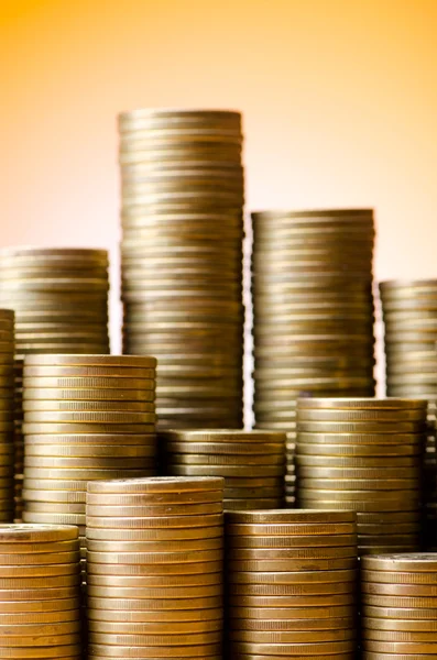 Golden coins in high stacks — Stok fotoğraf