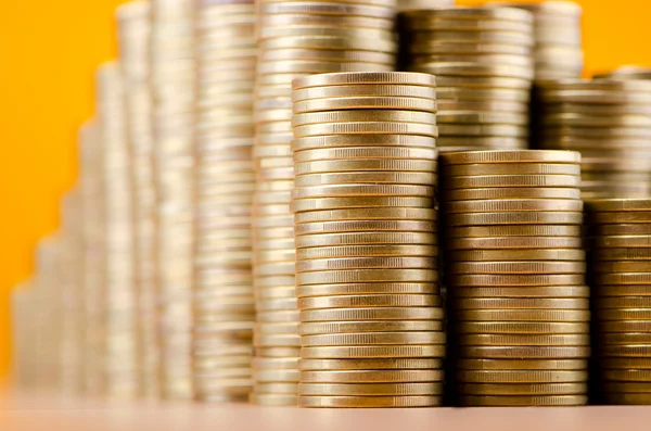 Golden coins in high stacks — Stock Photo, Image