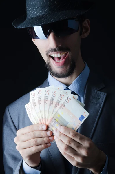 Człowiek z counterfeir pieniędzy — Zdjęcie stockowe