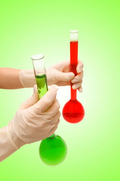 Hand with red and green tubes — Stock Photo, Image