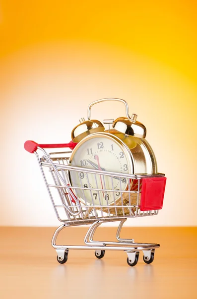 Концепция времени покупки с часами и корзиной — стоковое фото