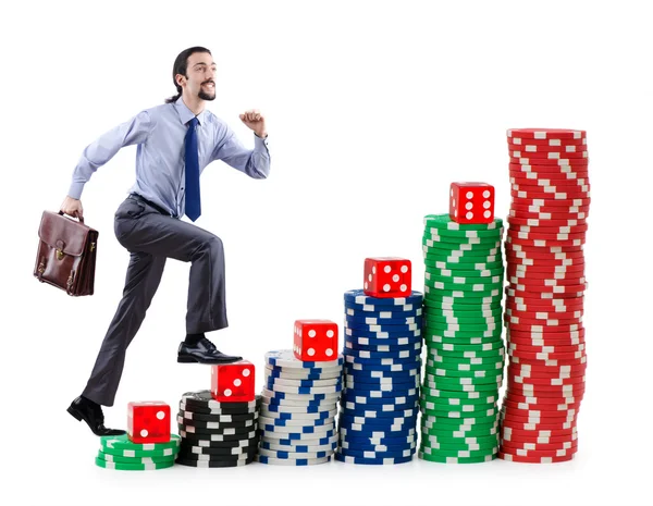 Podnikatel lezení hromádky kasino čipy — Stock fotografie