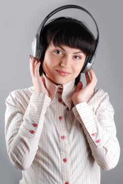 Beautiful businesswoman wearing a headset to talk with customer in the office clipart