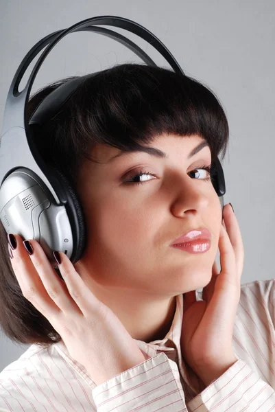 Young girl listening to music by headphones — Stock Photo, Image