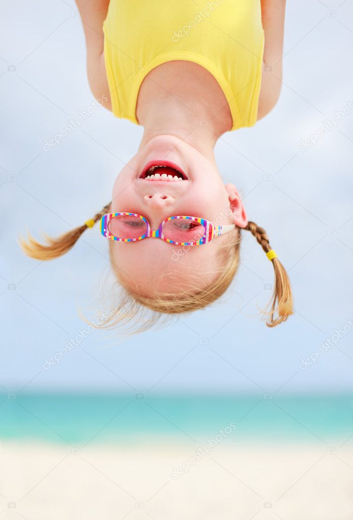 Happy little girl upside down