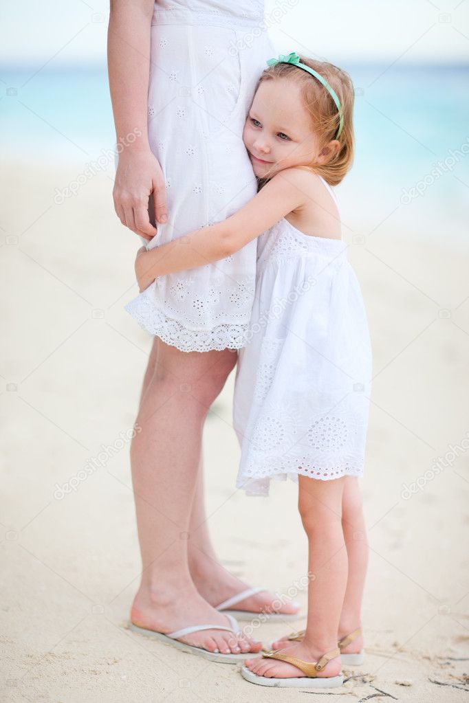 Little girl hugs her mom