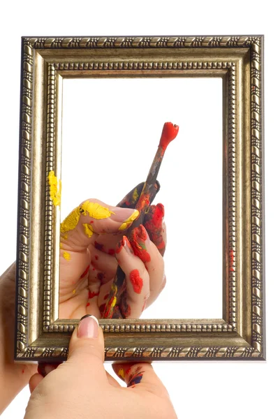Brush in hand with frame — Stock Photo, Image