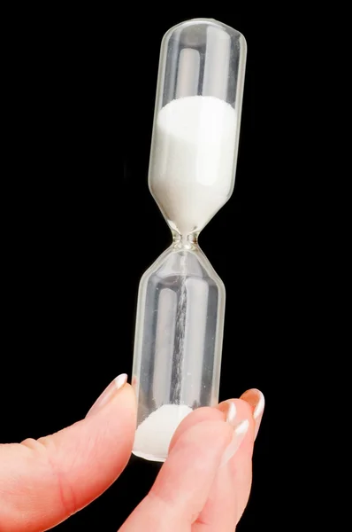 Hourglass in hand Stock Photo