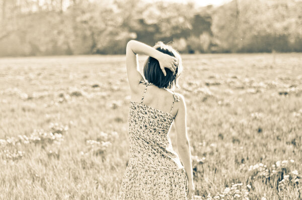Stylized photo of a young woman on the field