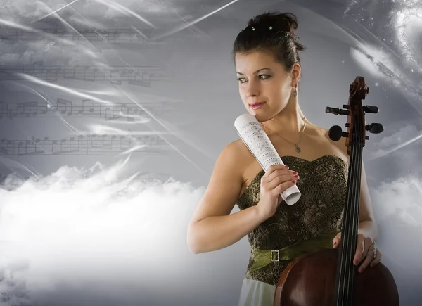 Woman with cello on a space background — Stock Photo, Image