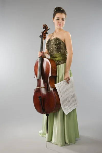 Beautiful woman with cello and score — Stock Photo, Image