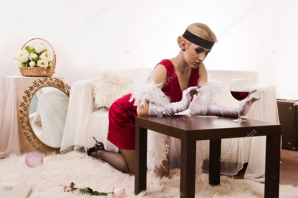 Sensual young lady in red sniffing cocaine (Imitation)