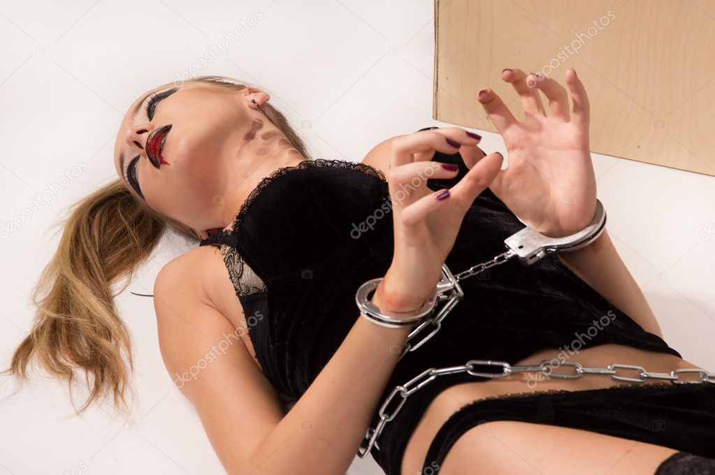 Dead blonde in the handcuffs lying on the floor (imitation)