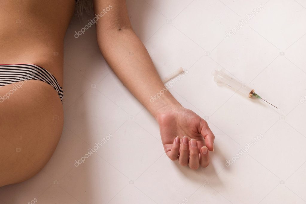 Overdosed woman in bikini lying on the floor