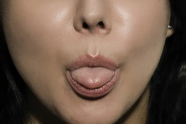 Girl shows tongue — Stock Photo, Image