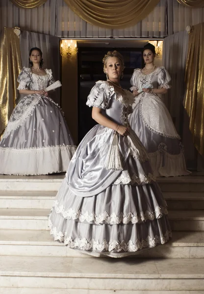 Three young women in ball gowns — Stock Photo, Image
