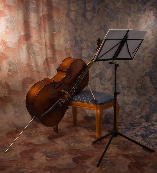 Oude cello en muziekstandaard — Stockfoto