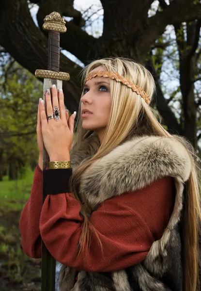 Viking girl with sword in a wood — Stock Photo, Image