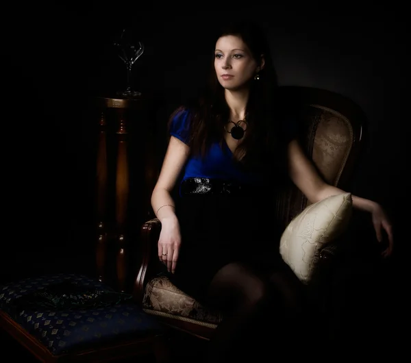 Portrait of woman seated in a chair — Stock Photo, Image