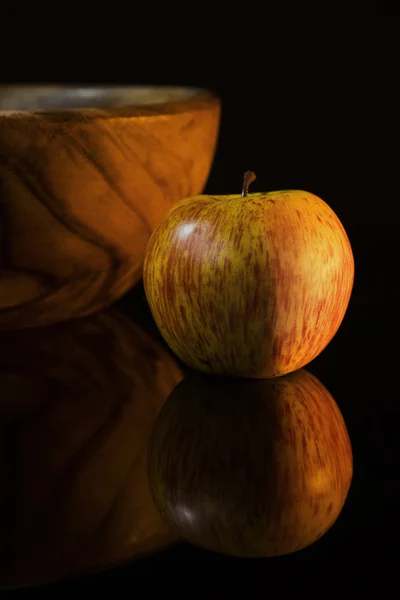Natura morta con mela e piatto di legno — Foto Stock