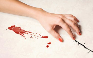 Woman's hand and a drop of blood