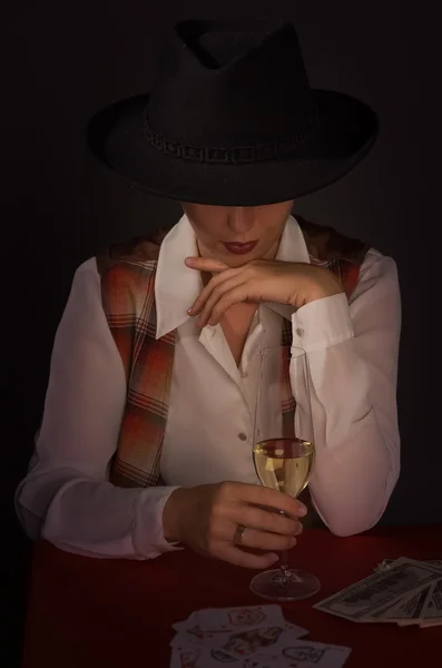 Beautiful woman in a black hat with a wine glass — Stock Photo, Image