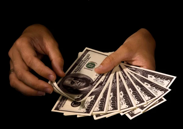 Женские руки с пачками долларов — стоковое фото