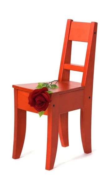 Red rose on a children's stool — Stock Photo, Image