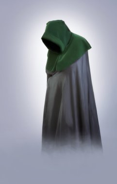 Man in an medieval hood and cloak in the fog clipart