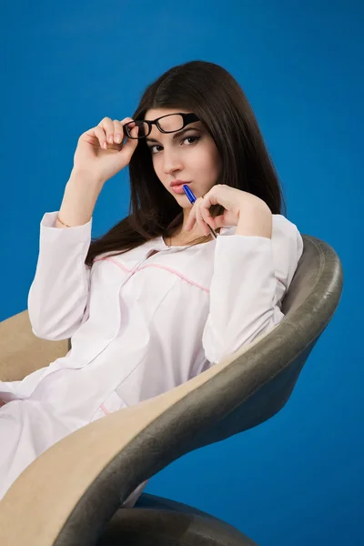 Pretty nurse sitting in a chair — Stock Photo, Image